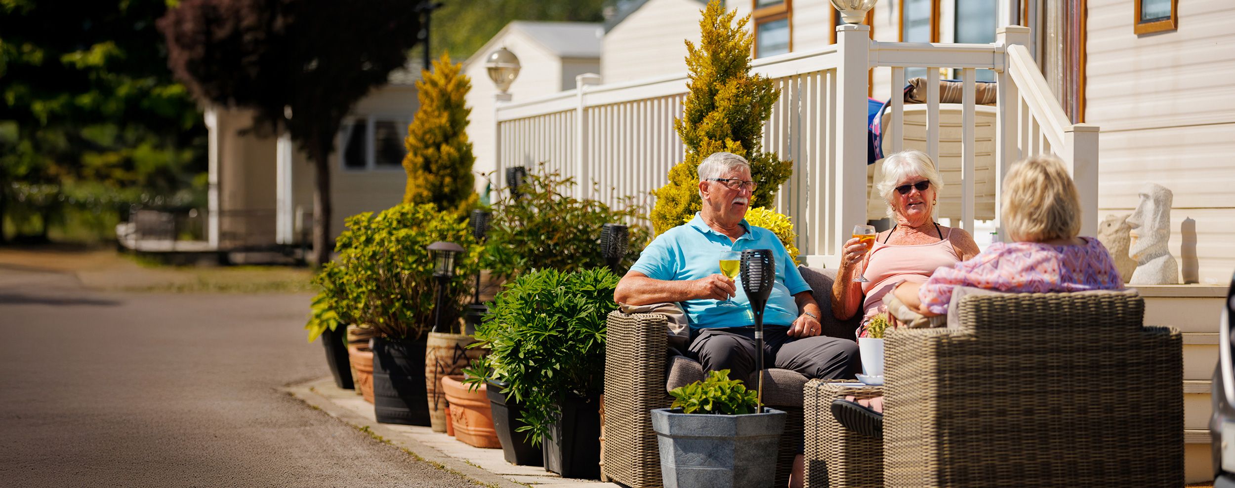 People sat outside a caravan